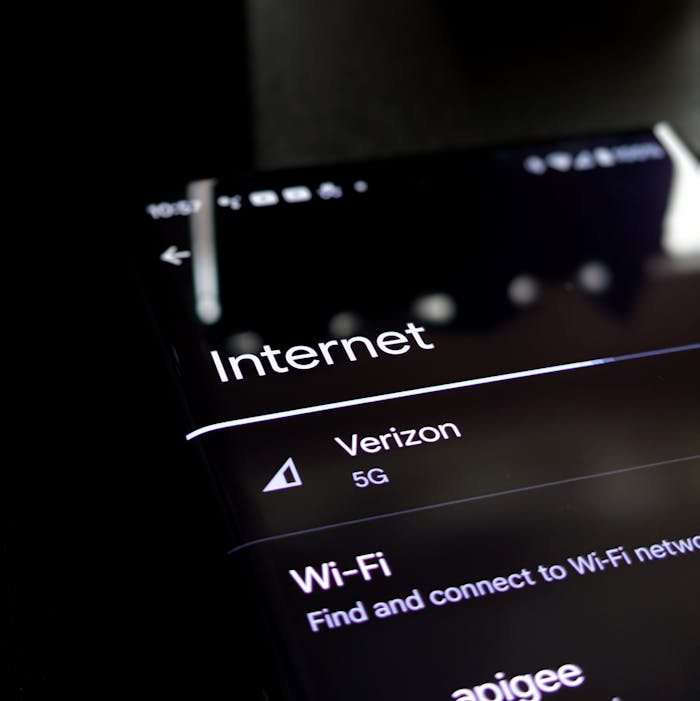 Close-up of a smartphone screen displaying internet connection details with Verizon 5G and Wi-Fi options.